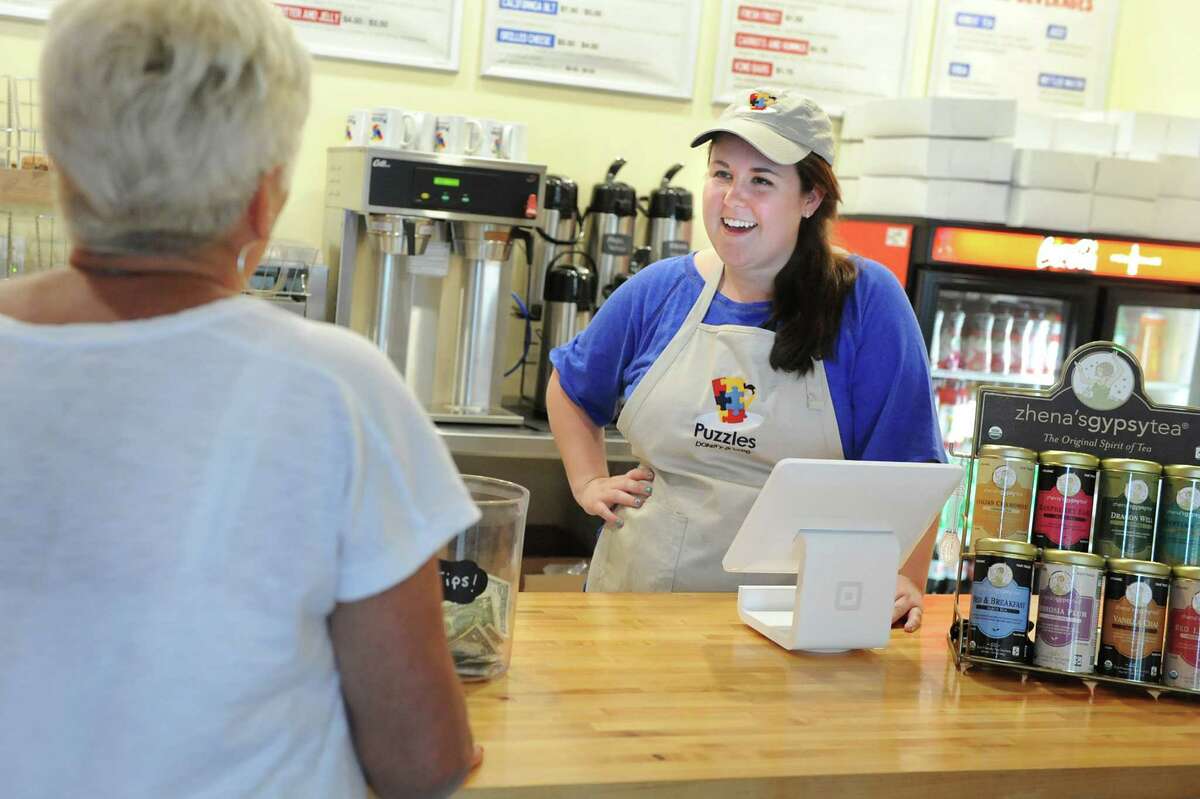 Owner Sara Mae Pratt, right, talks with a customer on Tuesday, June 16, 2015, at Puzzles Bakery and Cafe in Schenectady. (Cindy Schultz / Times Union)