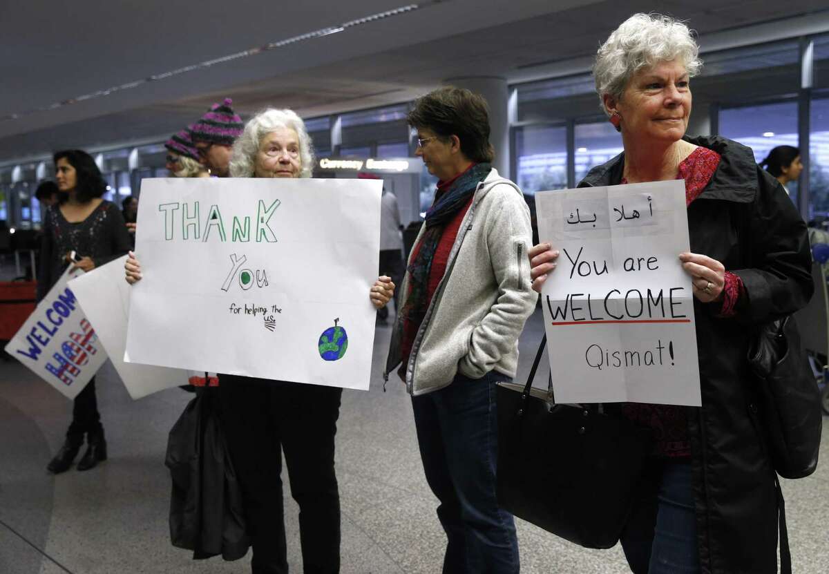 From left, Angel Rocha, Katherine Bass and Kaye Storm wait to greet Afghan interpreter Qismat Amin after his arrival at SFO in San Francisco, Calif. on Wednesday, Feb. 8, 2017. Amin's arrival ends a long effort by Amin and Matthew Ball, the Army captain he translated for during Ball's deployment in Afghanistan, to gain permanent U.S. residence.