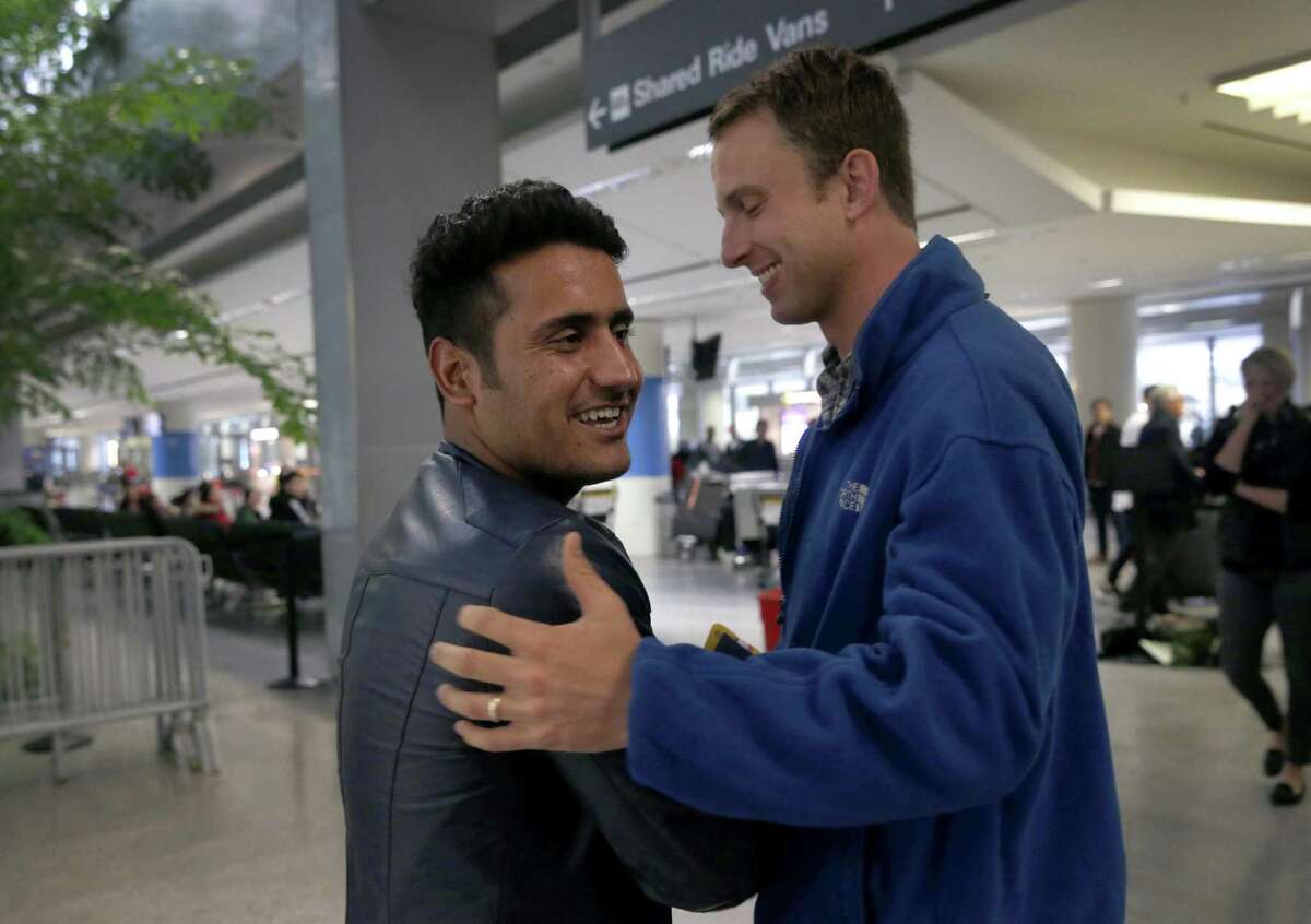Afghan interpreter Qismat Amin is greeted by Matthew Ball after Amin's arrival at SFO in San Francisco, Calif. on Wednesday, Feb. 8, 2017. Amin's arrival ends a long effort by Amin and Matthew Ball, the Army captain he translated for during Ball's deployment in Afghanistan, to gain permanent U.S. residence.