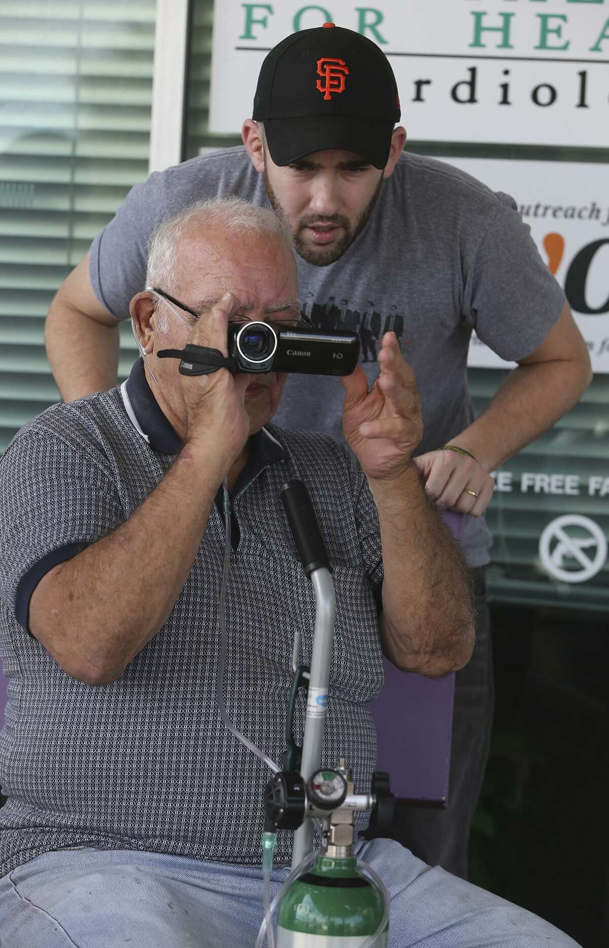 U.S. Air Force veteran John Geraci (seated) video tapes Wednesday February 8, 2017 with the help of instructor Dani Tenenbaum (wearing cap) during the Patton Veterans Project's I Was There Film Workshop currently being held at Cisneros Senior Center on Southwest Military Drive. The project is designed to help military families cope with stress or burdens in their lives. During the multi-day I Was There film workshops, participants are introduced to theoretical and practical aspects of filmmaking, and collaborate with veterans to conceive, shoot and edit short films.