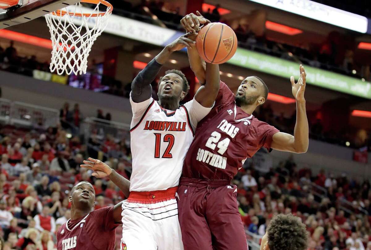 LOUISVILLE, KY - DECEMBER 10: Magok Mathiang #12 of the Louisville Cardinals and Marvin Jones #24 of the Texas Southern Tigers battle for a rebound during the game at KFC YUM! Center on December 10, 2016 in Louisville, Kentucky. (Photo by Andy Lyons/Getty Images)