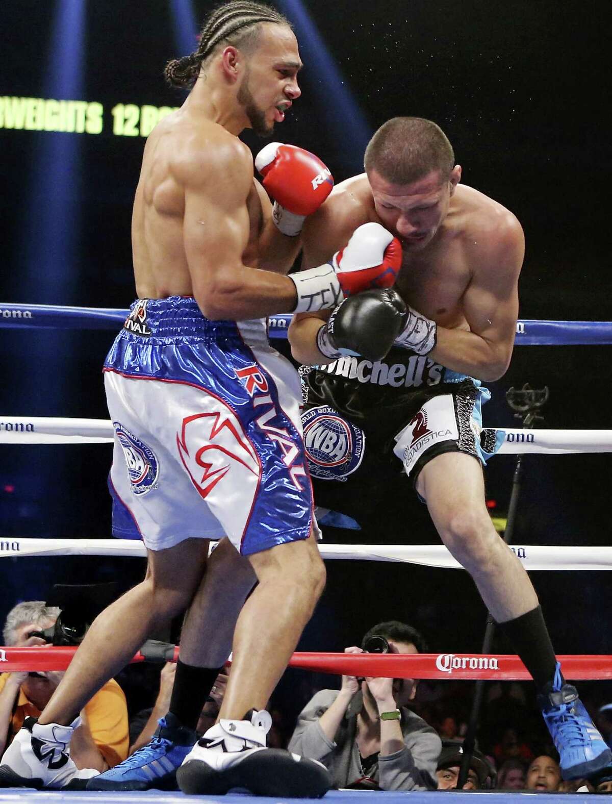 Keith Thurman (left) hits Jesus Soto Karass during their WBA interim welterweight fight — part of the “Danger Zone” boxing card — on Dec. 14, 2013 at the Alamodome.