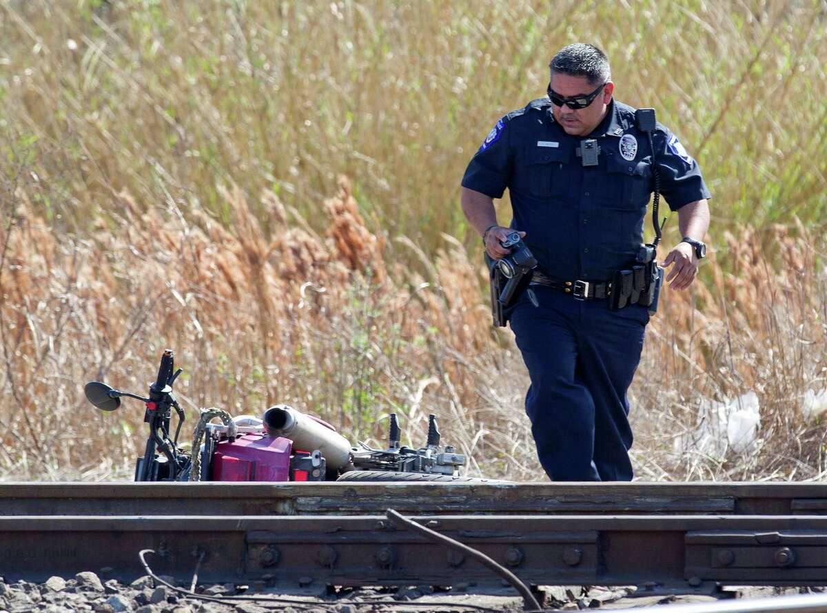 An officer with the Conroe Police Department documents the scene of a high-speed chase on railroad tracks near near South Pacific Street and Avenue A Thursday, Feb. 9, 2017, in Conroe. Taylor Starks, 19, was arrested for fellony avading with a motor vehicle after alledly leading officers on a short chase through Conroe.