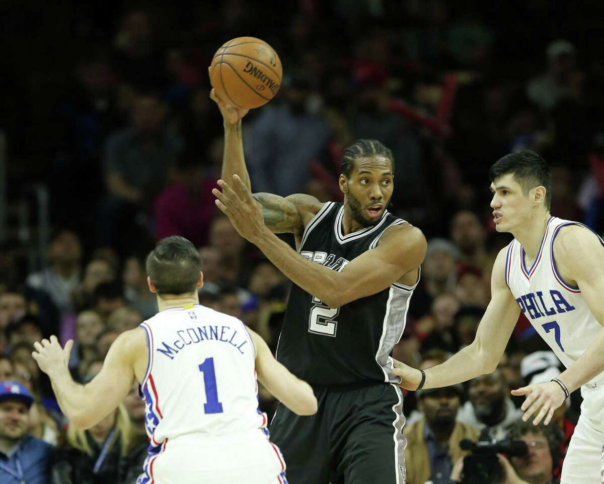 Spurs’ Kawhi Leonard passes the ball past the 76ers’ TJ McConnell (1) and Ersan Ilyasova during the third quarter on Feb. 8, 2017, at the Wells Fargo Center in Philadelphia.