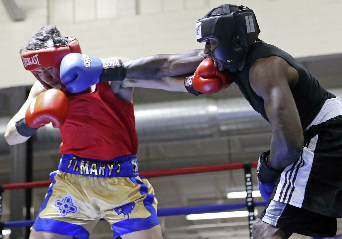 Luke Neftali Villafranca (left) and Terrence McKinney exchange punches during their light heavyweight championship bout in the semifinals of the 2016 San Antonio Regional Golden Gloves tournament on Feb. 26, 2016 at Woodlawn Gym.
