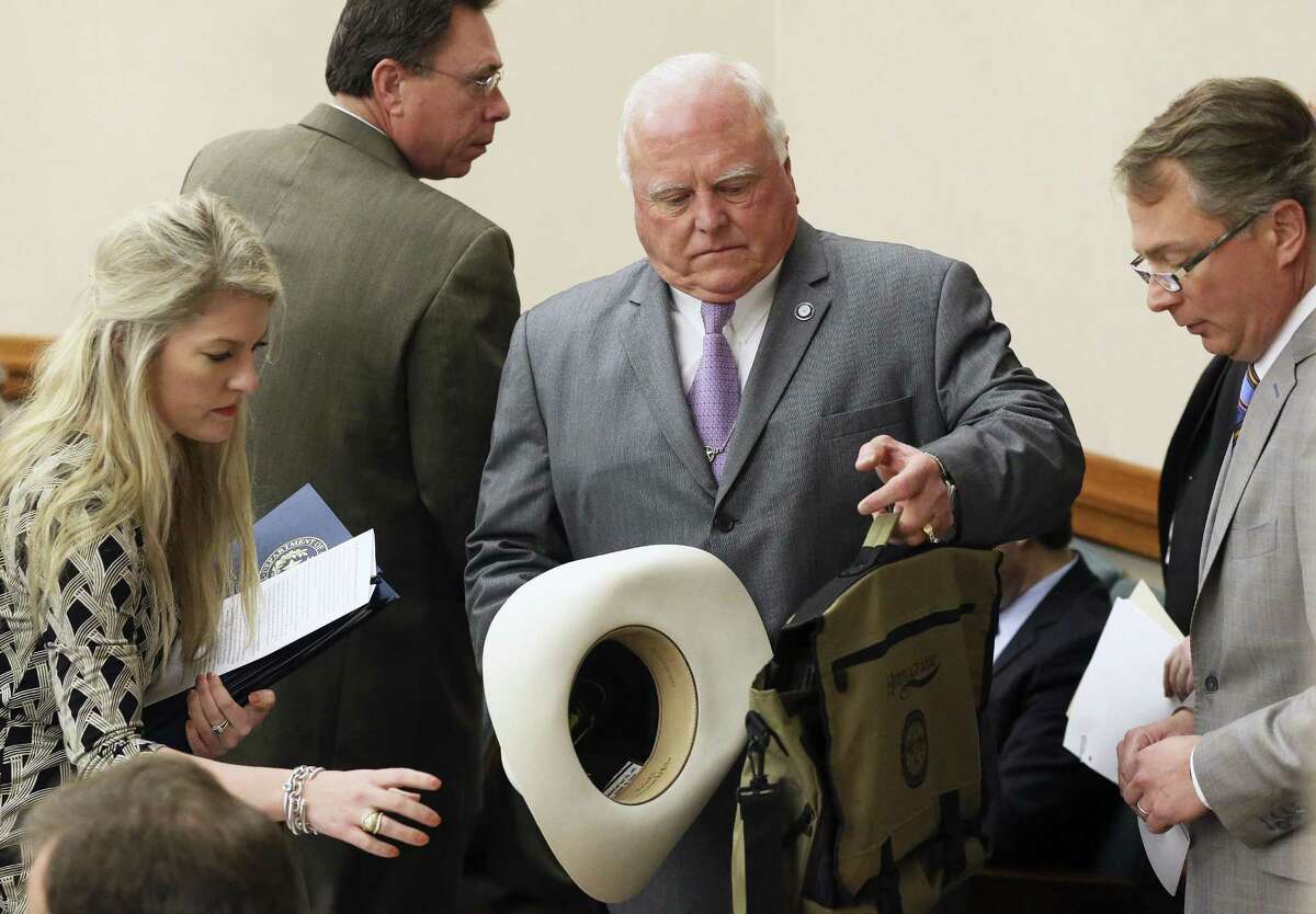 Texas Agriculture Commissioner Sid Miller unloads his gear on his arrival as the Senate Finance Committee hears presentations at the Capitol on February 9, 2017.