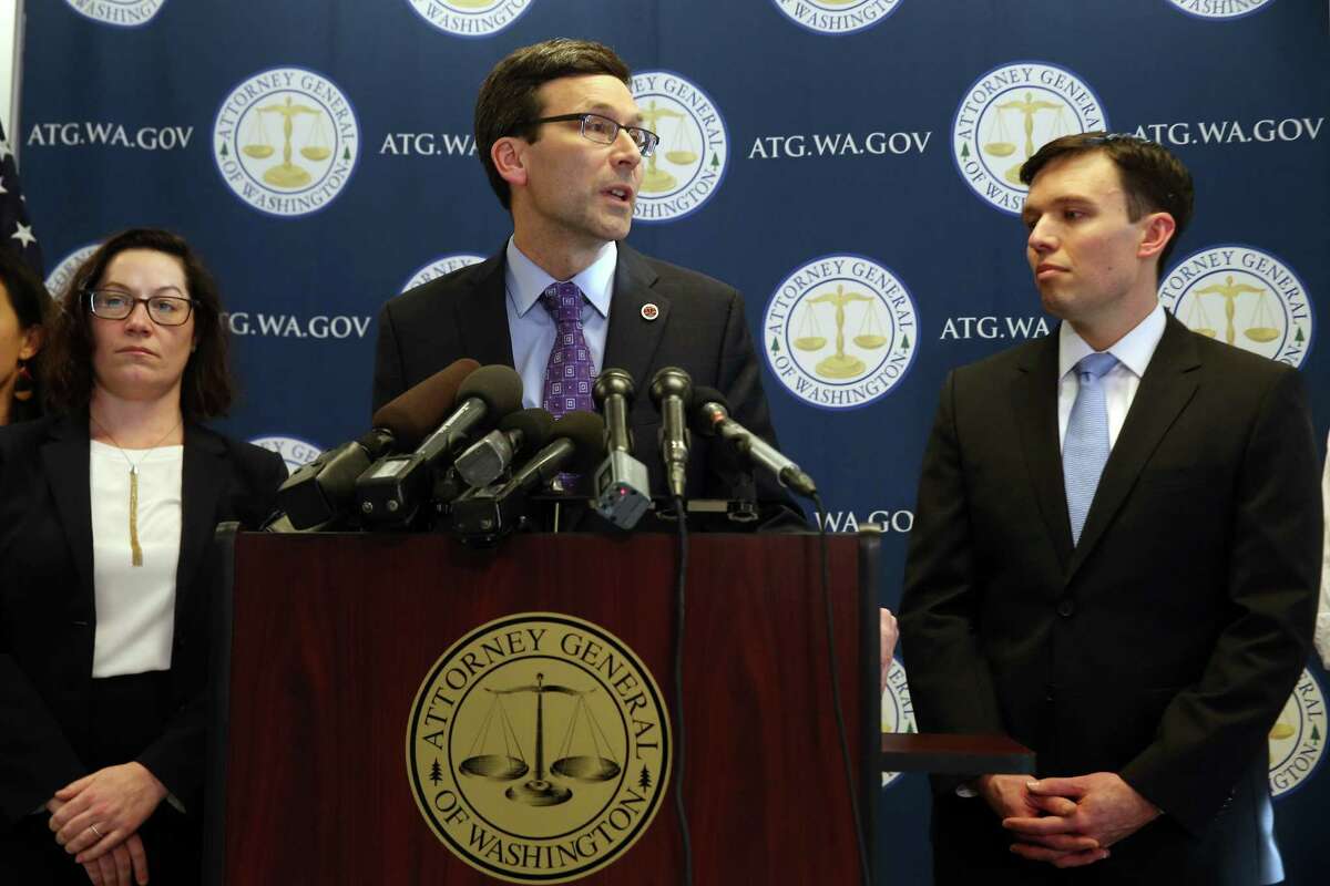 Flanked by Solicitor General Noah Purcell, right, and Civil Rights Unit chief Colleen Melody, left, Washington State Attorney General Bob Ferguson speaks after the U.S. Ninth Circuit Court of Appeals left in place a restraining order against immigration restrictions targeting Muslim-majority countries put forward by President Trump. Ferguson has put a spotlight on work of the AG's newly created civil rights and environmental units.