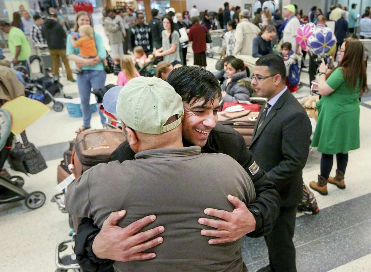 Noor﻿﻿hugs his friend Abdul Azizi, with whom he worked from 2003 to 2010 in Afghanistan, as he arrives at Bush IAH, on Thursday.﻿