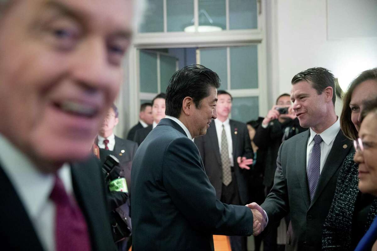 Japanese Prime Minister Shinzo Abe, accompanied by U.S. Chamber of Commerce CEO and President Tom Donohue (left) greets Sen. Todd Young, R-Ind., at the U.S. Chamber of Commerce.