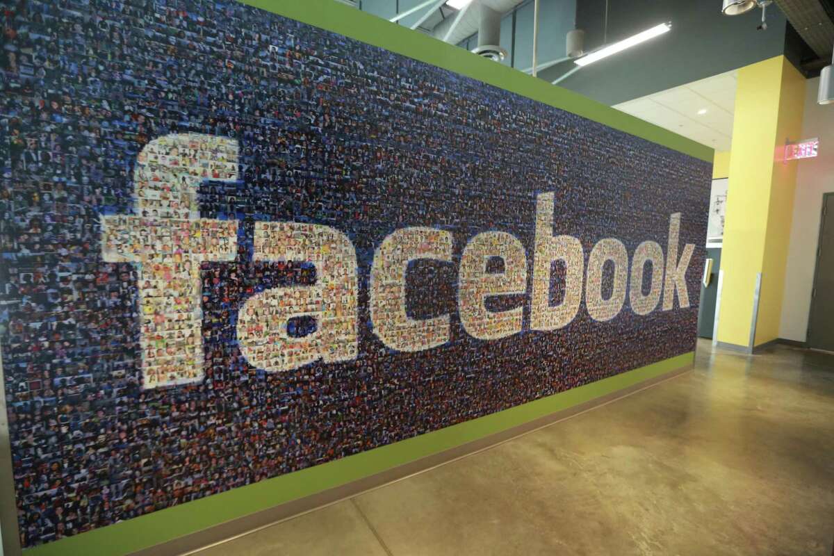 This Friday, Nov. 14, 2014 photo, shows a board with the Facebook logo inside the new Facebook data centers in Altoona, Iowa. Facing a torrent of criticism over its failure to prevent foreign interference during the 2016 election, the giant social network recently adopted new rules to make its advertising service harder to exploit.