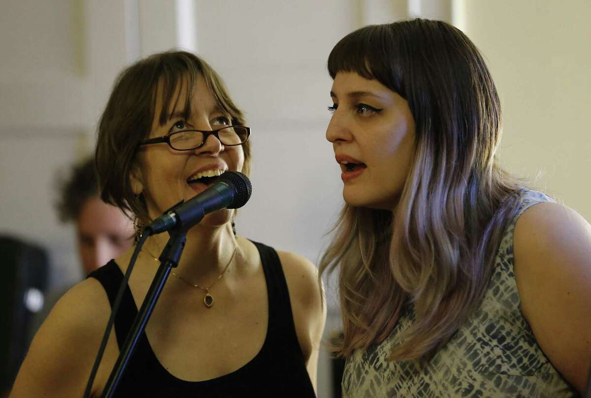 Singers Terry Garza (left) and her daughter, Carly, rehearse for a recent George Michael tribute show. Mother and daughter rarely perform together.