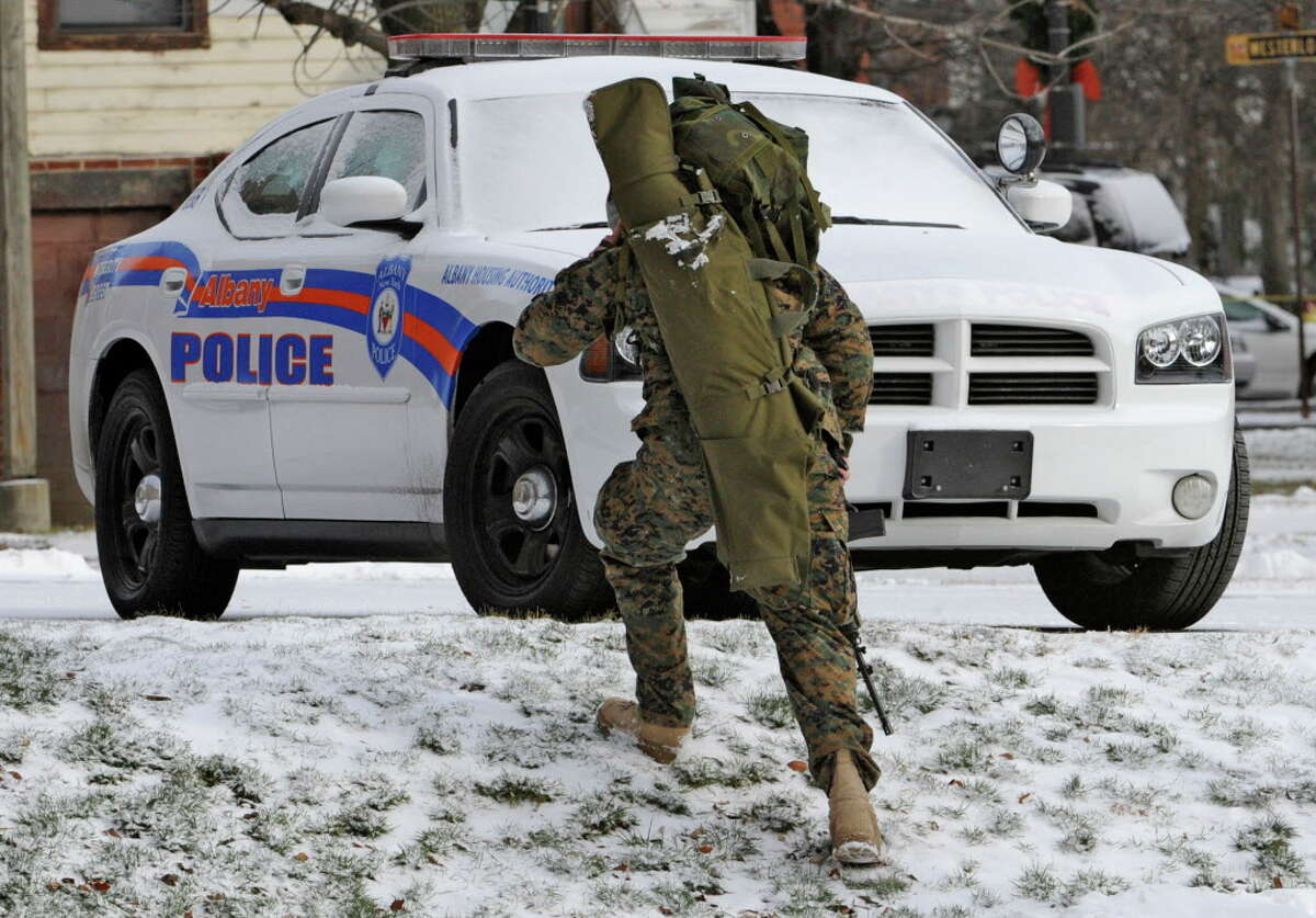 A SWAT team sharpshooter moves through the parking are near the the scene of a hostage situation on Westerlo St in Albany December 23, 2010. (Skip Dickstein / Times Union)