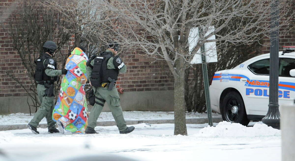 Albany Police SWAT team members move a person from building at the scene of a hostage situation on Westerlo St in Albany December 23, 2010. (Skip Dickstein / Times Union)