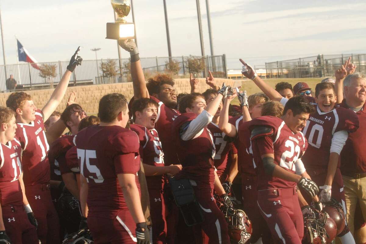 Abernathy's Xavier Rivera holds the area championship trophy aloft among his teammates last season. Rivera was voted an honorable mention defensive lineman on the Texas Sports Writers Association Class 2A all-state football team.