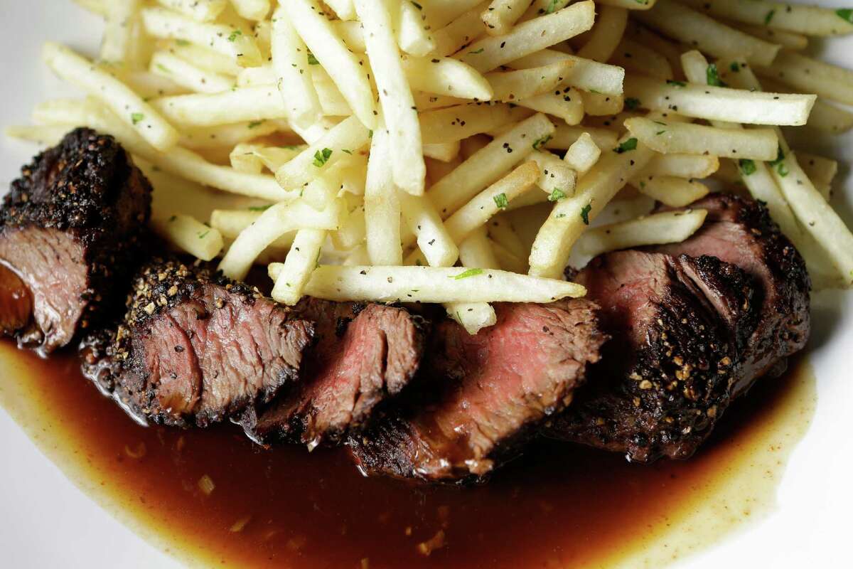Hanger steak au poivre with bourbon demi glace and french fries at Field & Tides, 705 E. 11th St. in the Heights. The new restaurant from chef Travis Lenig opens in the former Zelko Bistro space on Feb. 13.