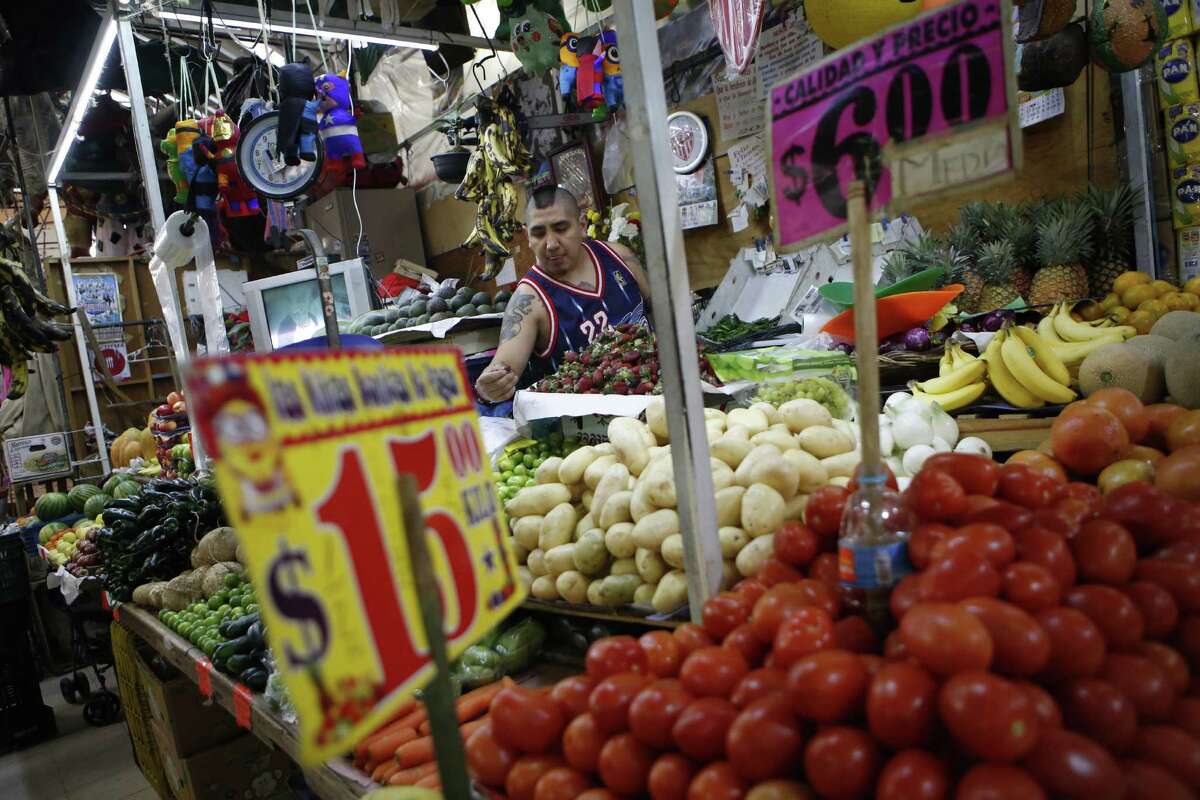 Vendor Luis Alberto Bautista arranges strawberries as he lays out fresh produce at the start of the day, in his vegetable stand in Mercado Medellin, in Mexico City on Feb. 2. Mexico is more than a leading exporter of produce to the United States. It is the worlds leading exporter of refrigerators and flat-screen TVs. Cars and trucks such as the Ram 1500 crew cab, Ford Fiesta and Chevrolet Trax fill U.S. dealer lots.