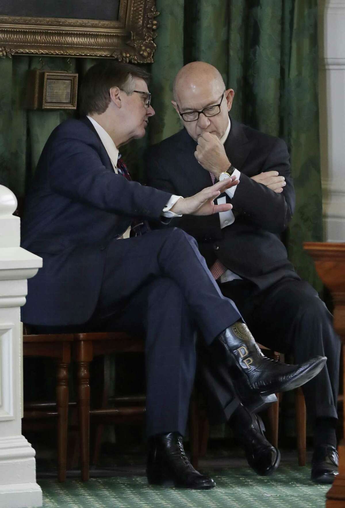Texas Lt. Gov. Dan Patrick, left, and Sen. John Whitmire, D-Houston, right, talk before the final vote on an anti-"sanctuary cities" bill, Wednesday, Feb. 8, 2017, at the Texas Capitol in Austin, Texas. A late tweak to the bill zooming through the state Senate calls for jail time for sheriffs and other law enforcement officials who refuse to enforce federal immigration law and potentially allows for their removal from office. (AP Photo/Eric Gay)