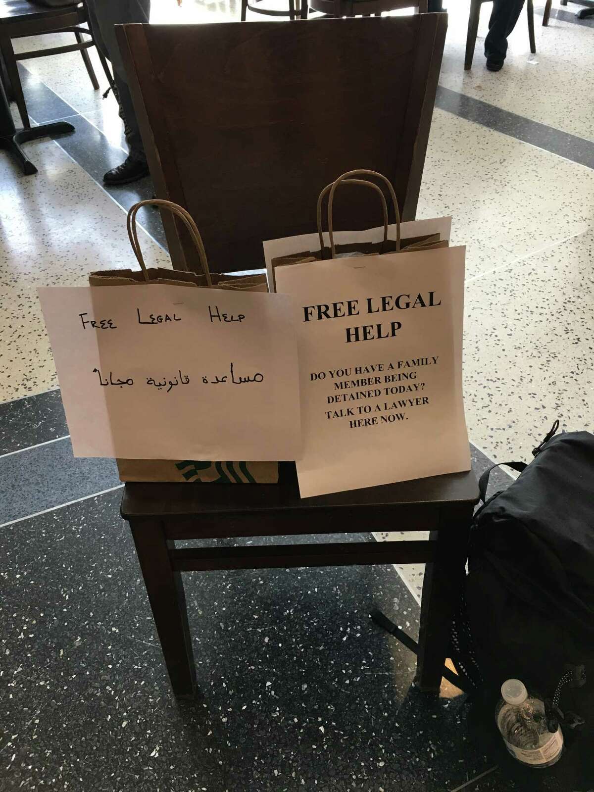 Lawyers set up signs at IAH to let travelers know they can get free help.