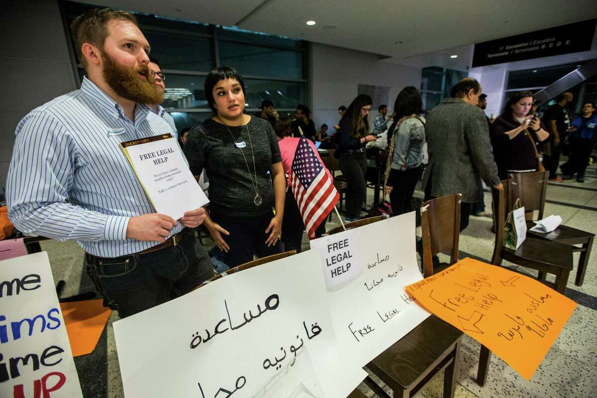 Monica Uddin, center, and other lawyers stand ready to offer free legal help at George Bush Intercontinental Airport during a demonstration protesting President Donald Trump's executive order on immigration. Lawyers across the country headed to airports to aid refugees.