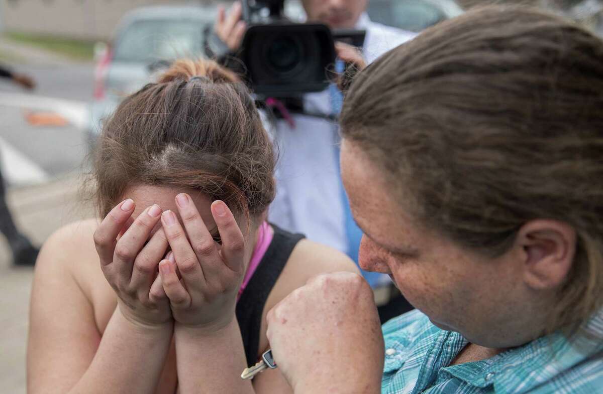 Angle Velazquez is overcome with emotion as she speaks to local media about how the U.S. Immigration and Customs Enforcement arrested her fiance Hugo Baltazar-Ramirez on Friday. At right, Teresa Velazquez consoles her daughter.﻿