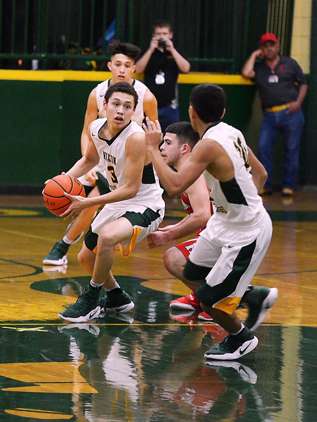 Nixon’s AJ Melendez handles the ball in a crowd as the Mustangs topped Roma 79-67 on Friday night, clinching the No. 2 seed in District 31-5A.