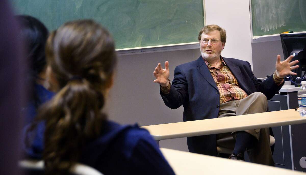 In this 2008 photo provided by Whitman College, U.S. District Judge James Robart, right, talks with students at the college in Walla Walla, Wash. Robart ruled Friday, Feb. 3, 2017, in federal court in Seattle to suspend President Donald Trump's travel and refugee ban. (Greg Lehman/Whitman College via AP)
