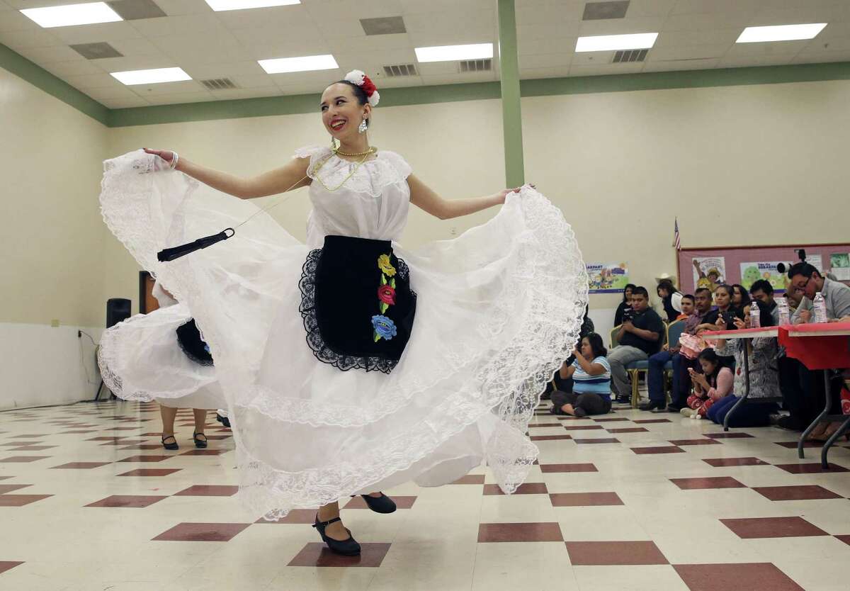Sydney Goldberg turns with a group performing a folkloric dance as students from the School of Science & Technology compete in the 12th annual Languages Other Than English talent contest at the Discovery campus.