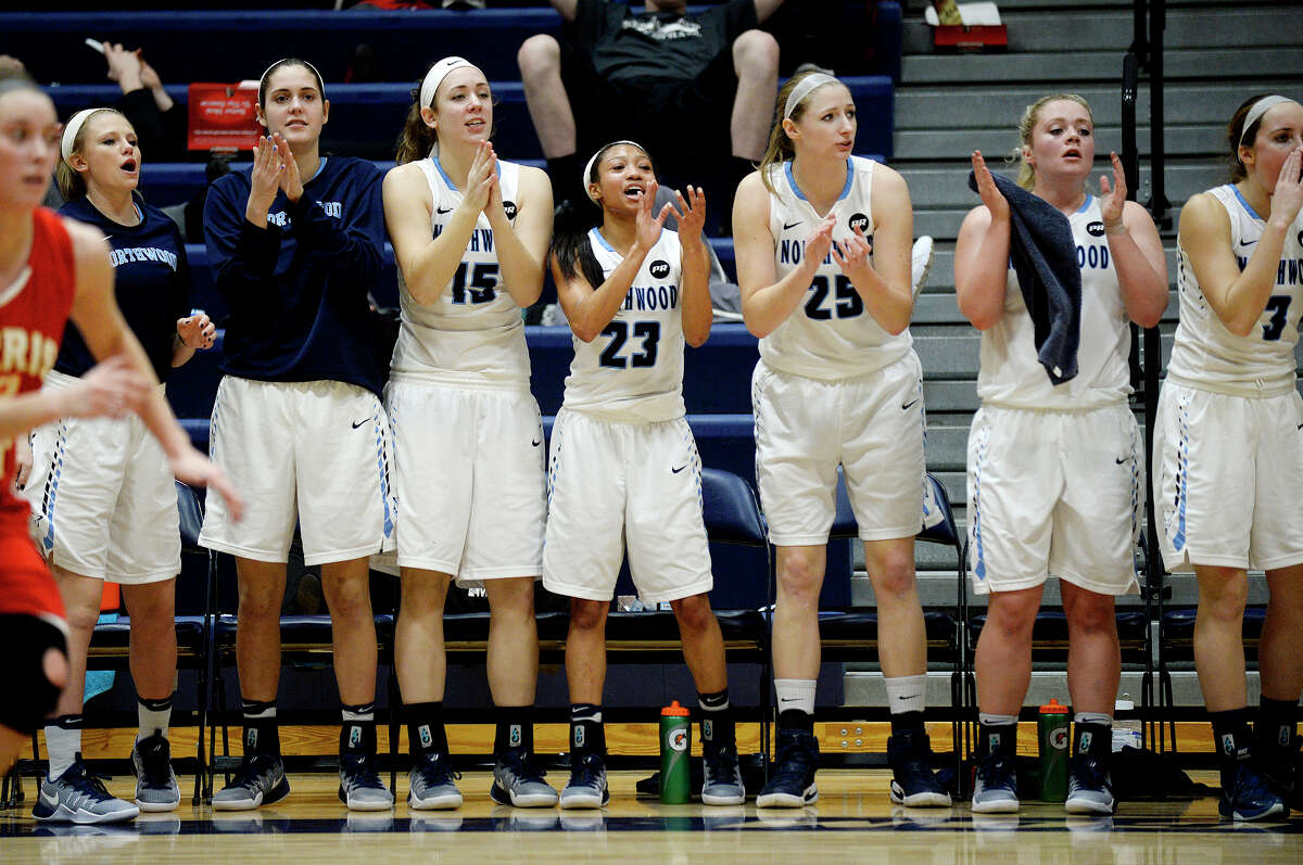 The Northwood bench celebrates during the third quarter of the Timberwolves' game against Ferris State on Saturday at Northwood University. Northwood won 55-50.