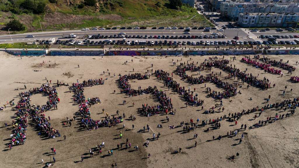 Thousands Of Protesters Spell Out Resist On San Francisco S Protesters Gather To Spell Out Resist On Ocean Beach In San Francisco