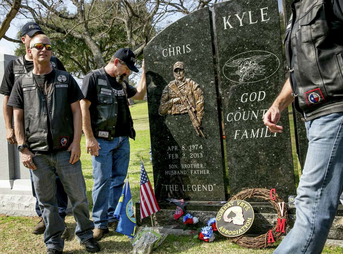 Gulf War veteran Mark Hallstein of San Antonio pauses at Chris Kyle’s grave at Texas State Cemetery.