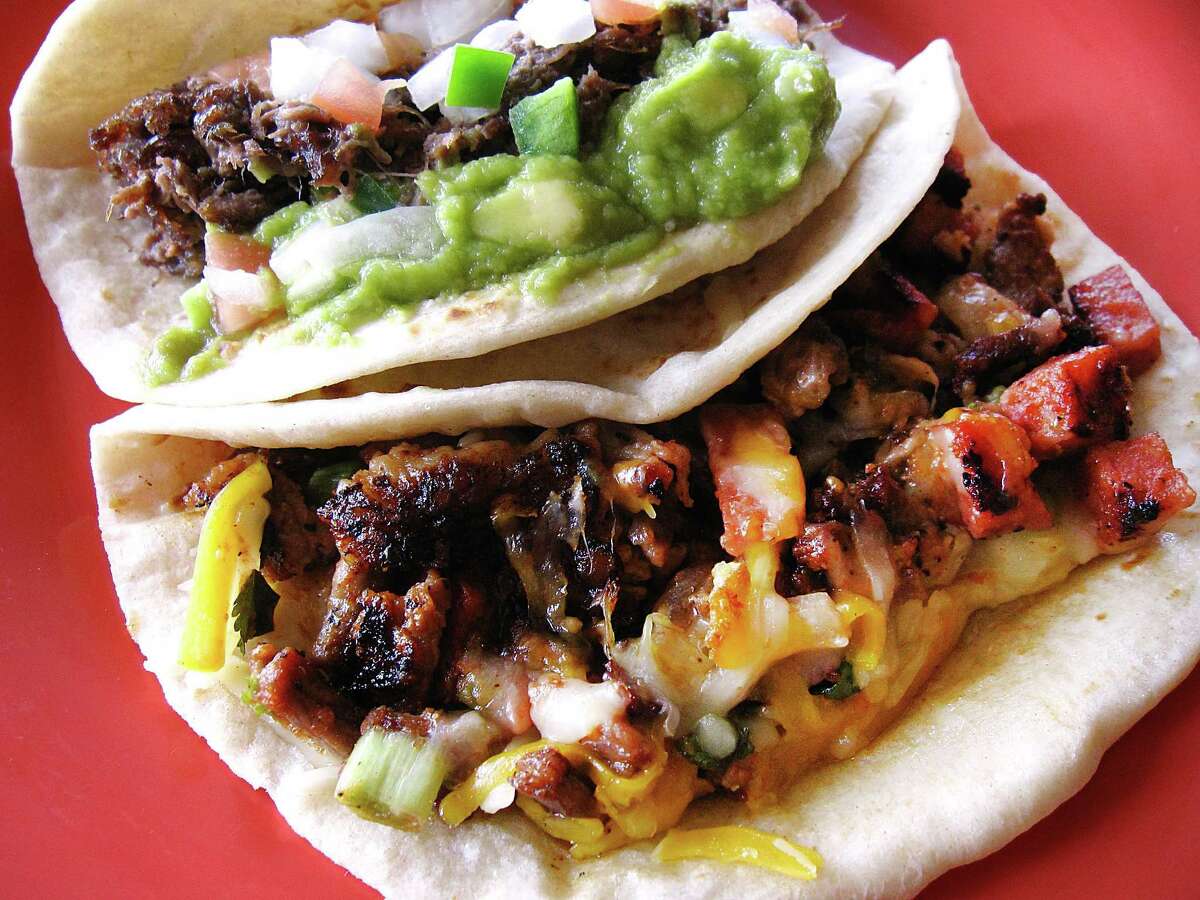 "El Mexicano" taco, left, with barbacoa, guacamole and pico, and the Holiday Taco with sausage, carne asada, beans and cheese, both on handmade flour tortillas from Don Jose Mexican Cafe.