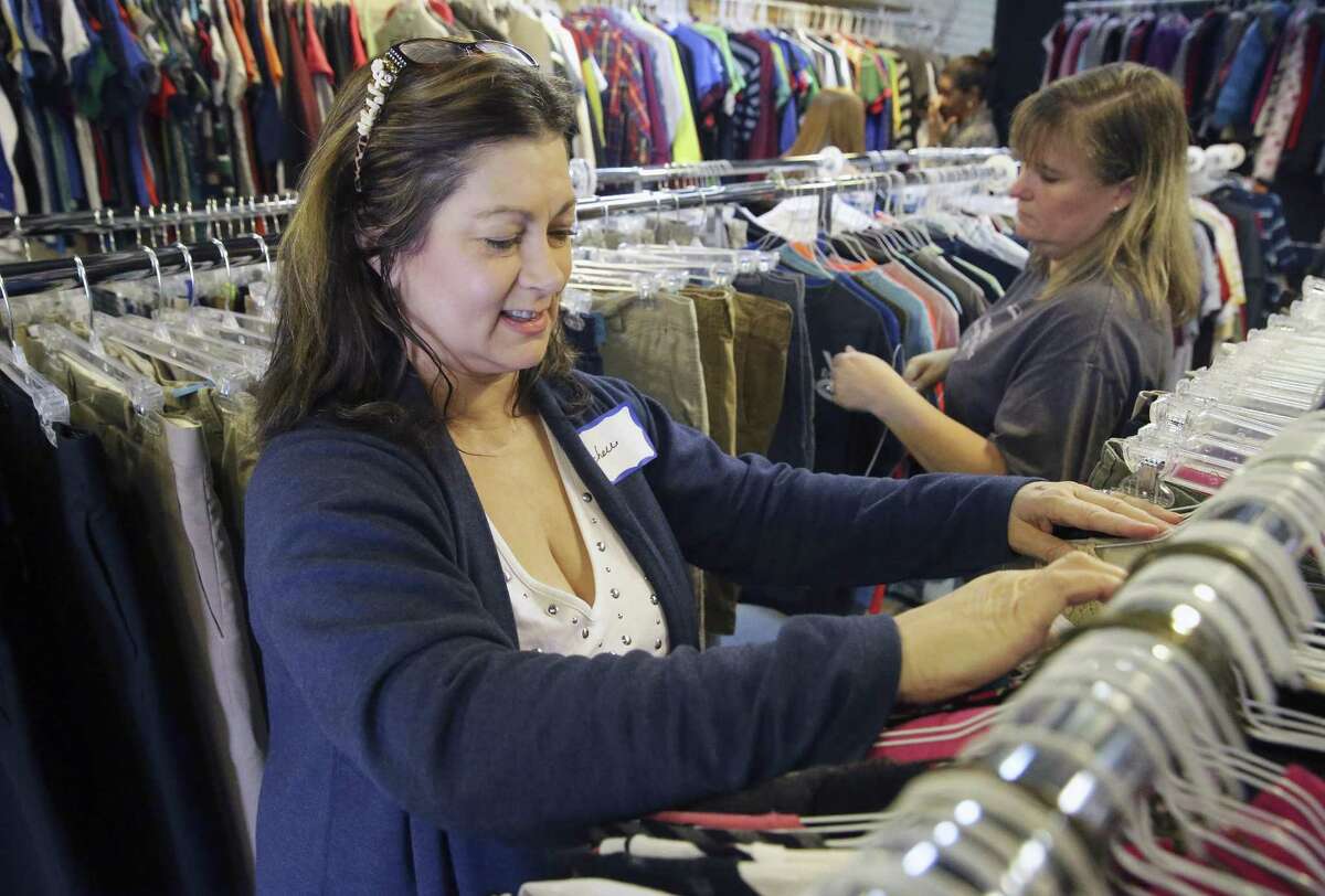 Michelle Green goes through a rack as North East ISD PTA volunteers sort and display clothing for the opening of the district's store, the Clothes Closet, which provides used clothing to students on January, 25, 2017.