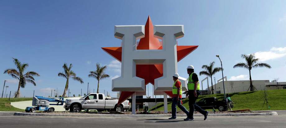 Houston Astros Ownership Group To Turn Palm Beach Office Building Workers Walk Past The Houston Astros Team Logo Outside An Entrance At Ballpark Of