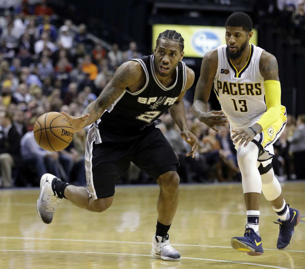 San Antonio Spurs' Kawhi Leonard is chased by Indiana Pacers' Paul George during the second half of an NBA basketball game, Monday, Feb. 13, 2017, in Indianapolis. San Antonio defeated Indiana 110-106. (AP Photo/Darron Cummings)