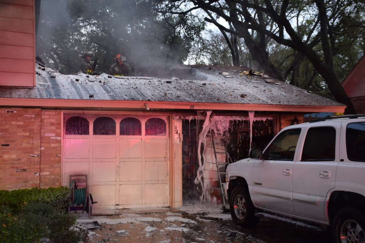 San Antonio firefighters work to extinguish a house fire caused by a lightning strike on the North Side on Tuesday, Feb. 14, 2017.