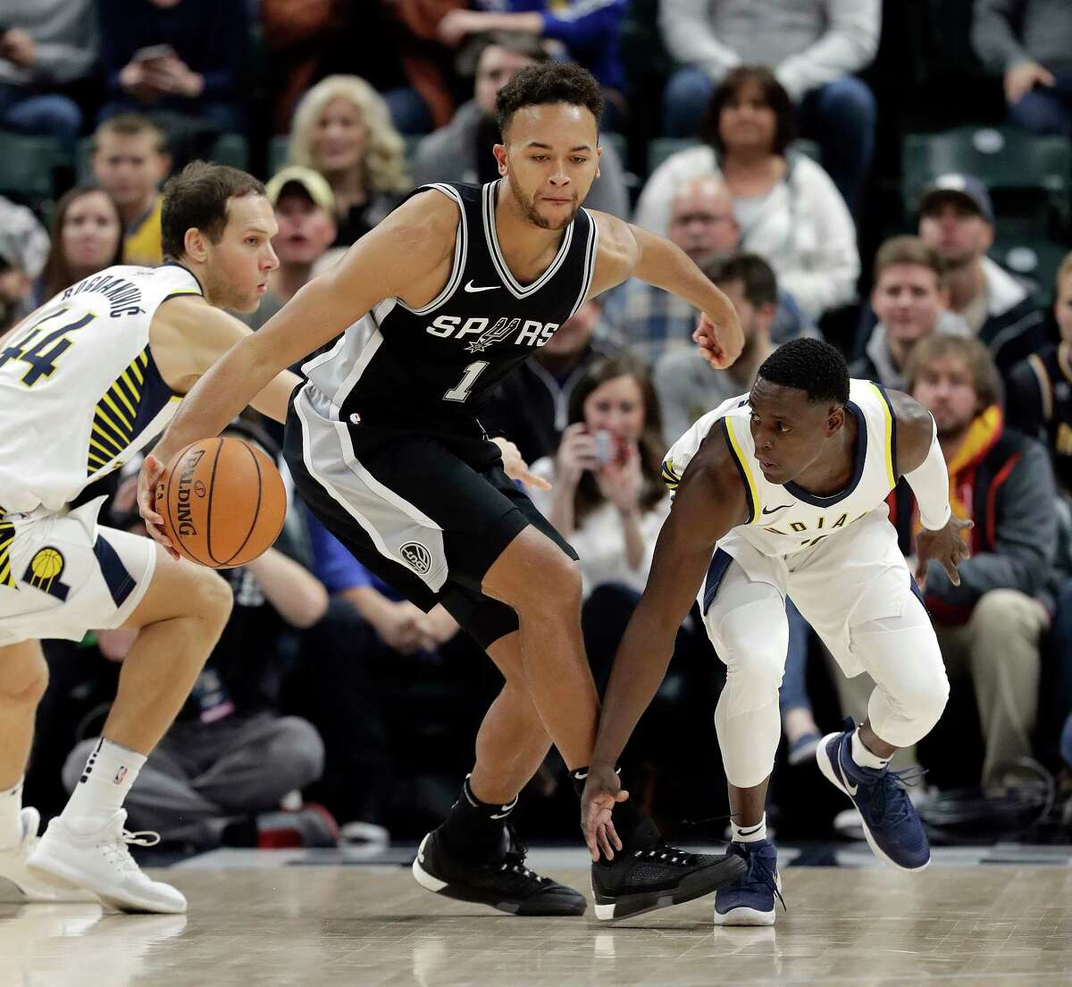 San Antonio Spurs' Kyle Anderson (1) is defended by Indiana Pacers' Darren Collison (2) during the first half of an NBA basketball game, Sunday, Oct. 29, 2017, in Indianapolis. (AP Photo/Darron Cummings)