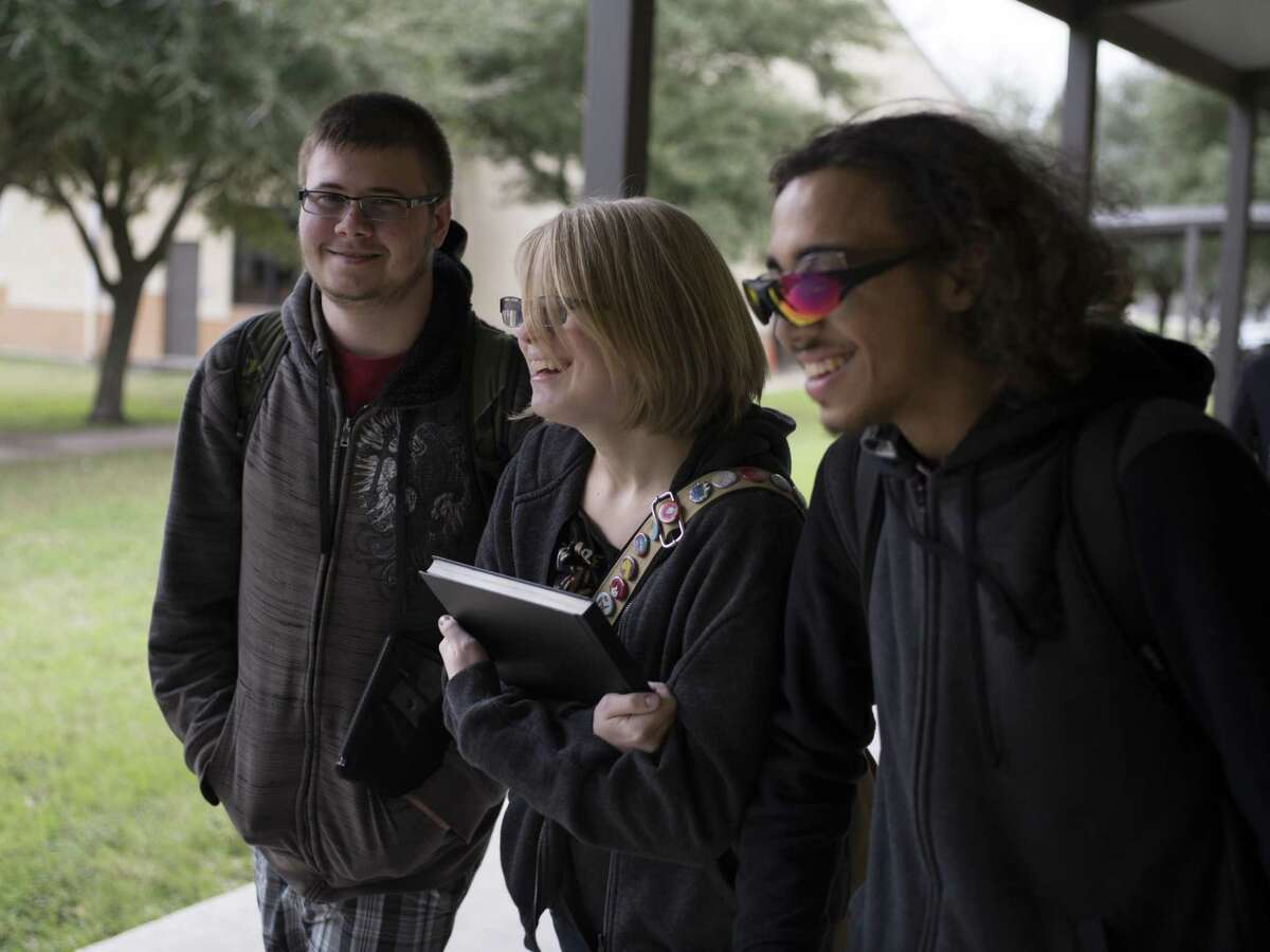 Alyssa Scott, 17, who is a senior at Stacey Junior-Senior High School, center, walks with her friends Samuel Mackall, left, and Devon Howard, right, from their class to lunch in San Antonio, Texas on January 6, 2017. Scott's family moved to San Antonio from California late this past year and Scott was unable to graduate on-time from her new school. The military interstate compact allows students transferred for their parent's military job, who would not qualify to graduate on time or with their preferred classes at their new school, to graduate from their previous school while attending classes wherever they have been transferred. Scott will graduate this coming May.