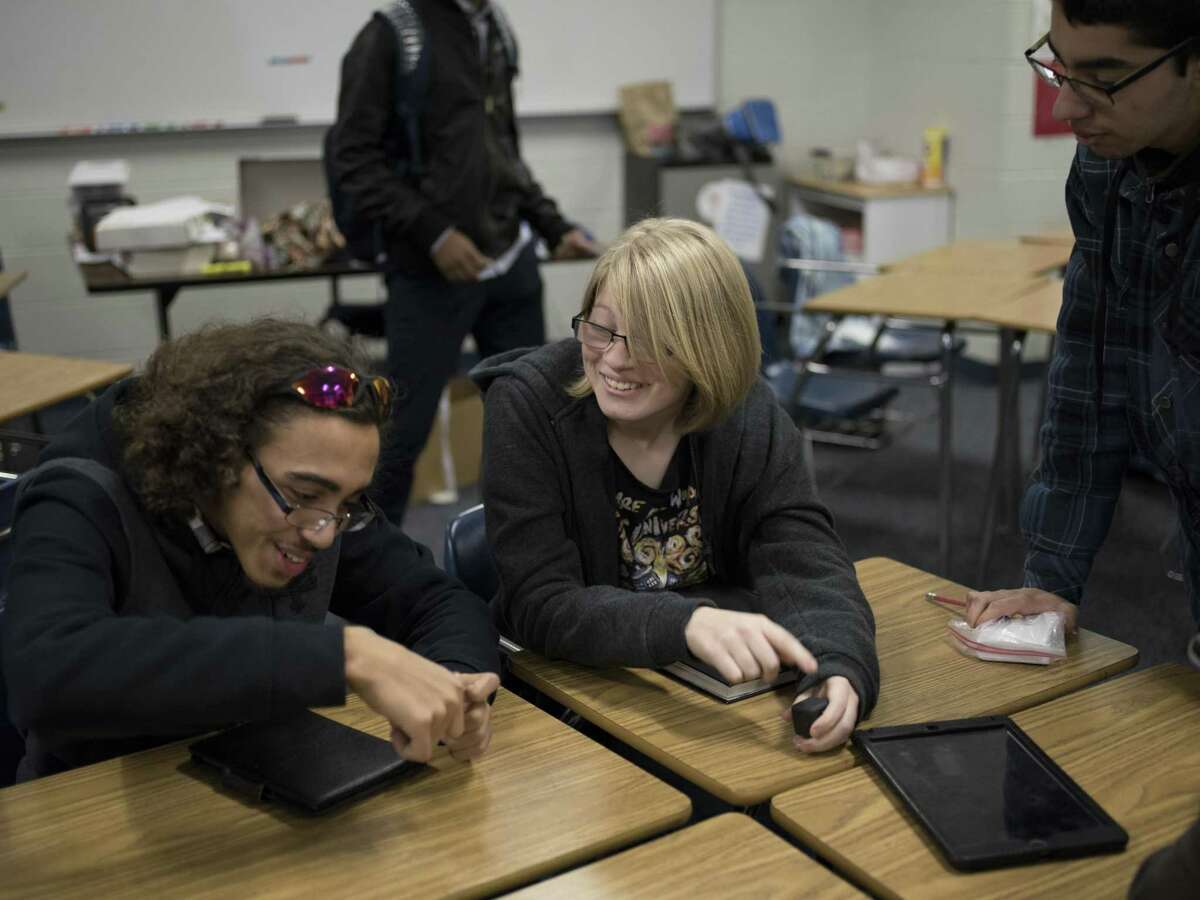 Alyssa Scott, 17 ( center), talks with friends Devon Howard and Isaac Coronado. Her family moved to San Antonio from California last year, and she was at risk of being ineligible to graduate on time.