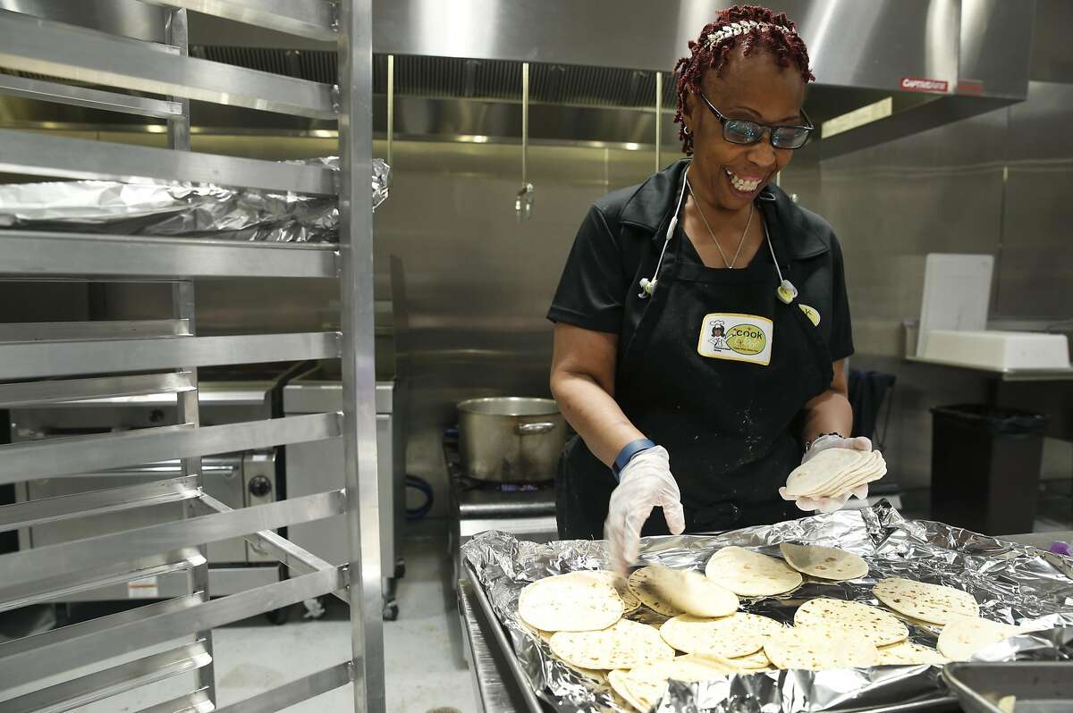 Renee Jackson and her catering business prepares school lunches for students at six different schools in a shared kitchen space in Oakland, Calif. on Tuesday, Feb. 14, 2017. An assembly bill introduced at the State Capitol would permit cooks in home kitchens to sell meals to the public, which is currently illegal under the California Health and Safety Code.