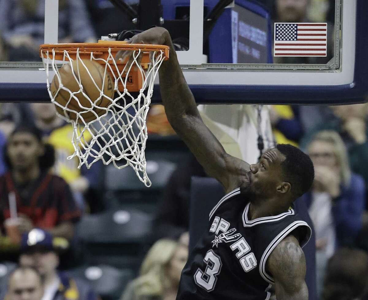 Spurs’ Dewayne Dedmon dunks during the first half against the Indiana Pacers on Feb. 13, 2017, in Indianapolis.