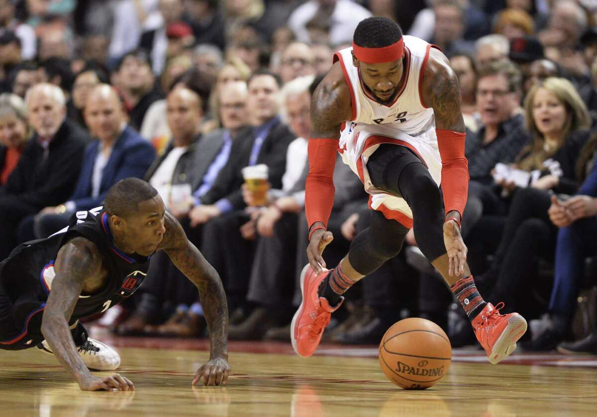 Raptors forward Terrence Ross picks up a loose ball as Clippers guard Jamal Crawford dives during the first half in Toronto on Feb. 6, 2017.