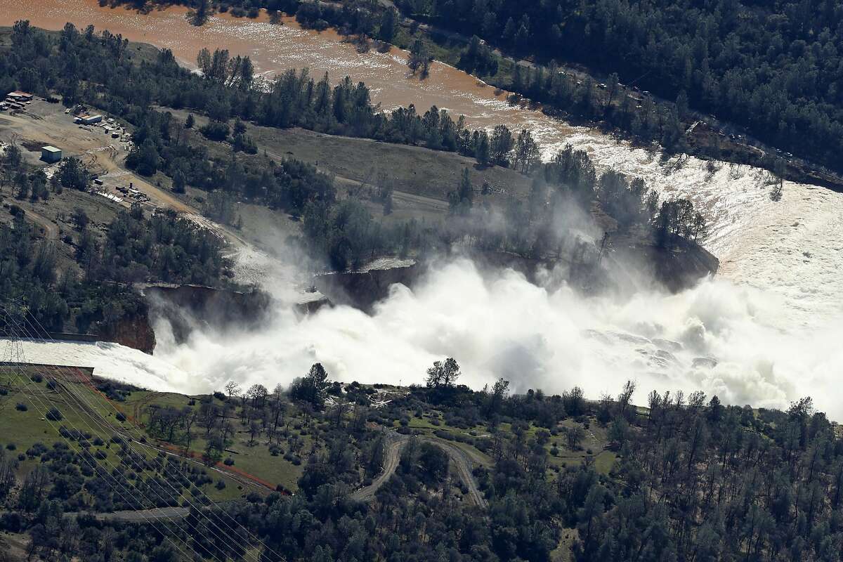 Water flows out of the damaged spillway at Oroville Dam in Oroville, Calif., on Tuesday, February 14, 2017.