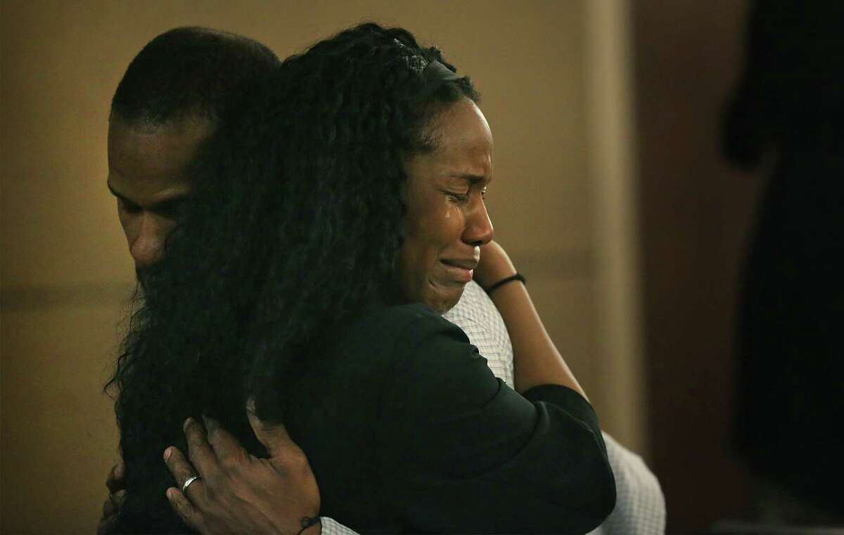 Qwalion Busby, left, charged with injury to a child by omission in regard to his son, who died after a severe infection in 2015, is embraced by a grieving family member after hearing the guilty verdict read in the Cadena-Reeves Justice Center, on Tuesday, Feb. 14, 2017. Busby and his wife Marquita Johnson were found guilty.