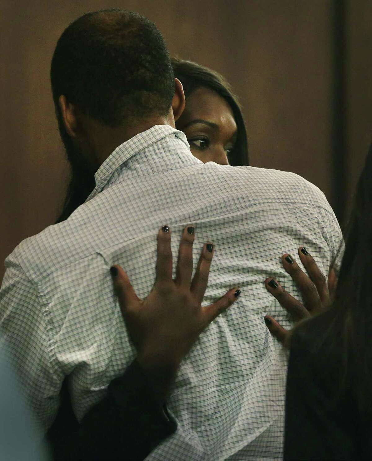 Marquita Johnson, right, embraces her husband Qwalion Busby, left, after being found guilty of injury to a child by omission in regard to their son, who died after a severe infection in 2015 appear in the Cadena-Reeves Justice Center, on Tuesday, Feb. 14, 2017.