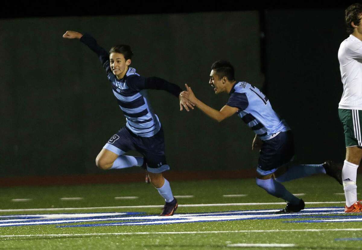 Johnson’s Brandon Bradford (left) celebrates his goal with teammate Jose Silerio during a District 26-6A high school soccer game against Reagan on Feb. 14, 2017.