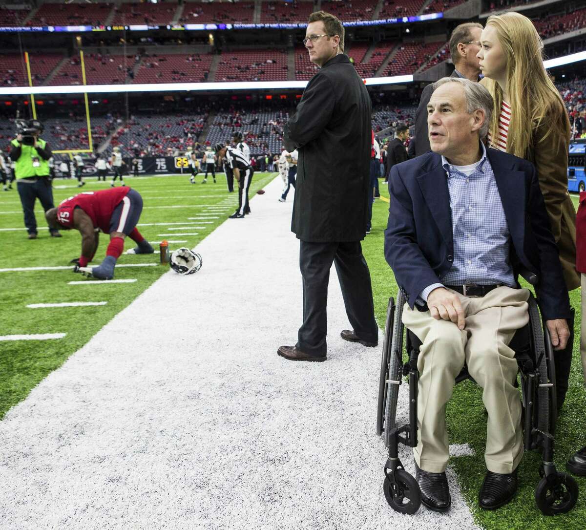 Gov. Greg Abbott watches warm ups of the Houston Texans before the Dec. 18 game against the Jacksonville Jaguars.