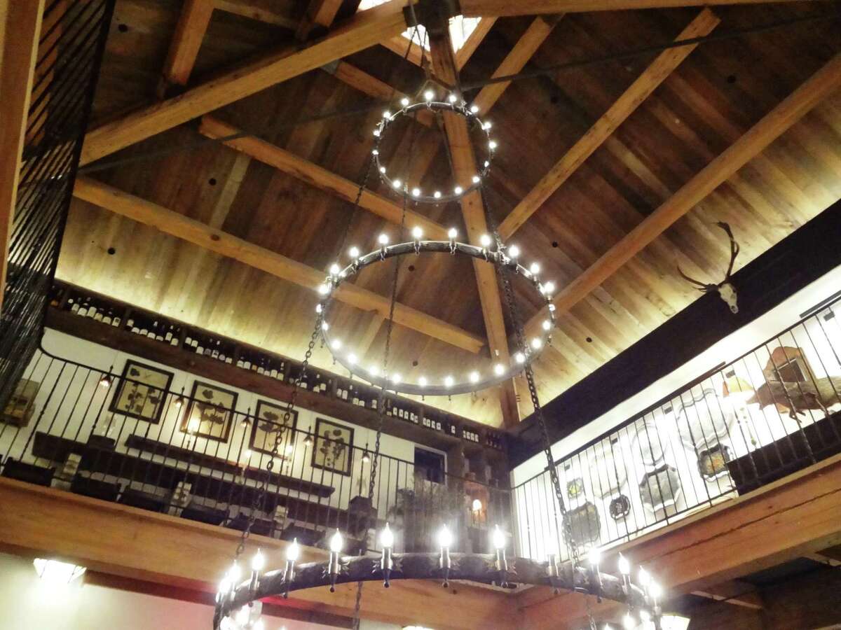 A custom steel fabricated chandelier hangs in the hexagonal cupola made with reclaimed wood from the old Joske’s store.