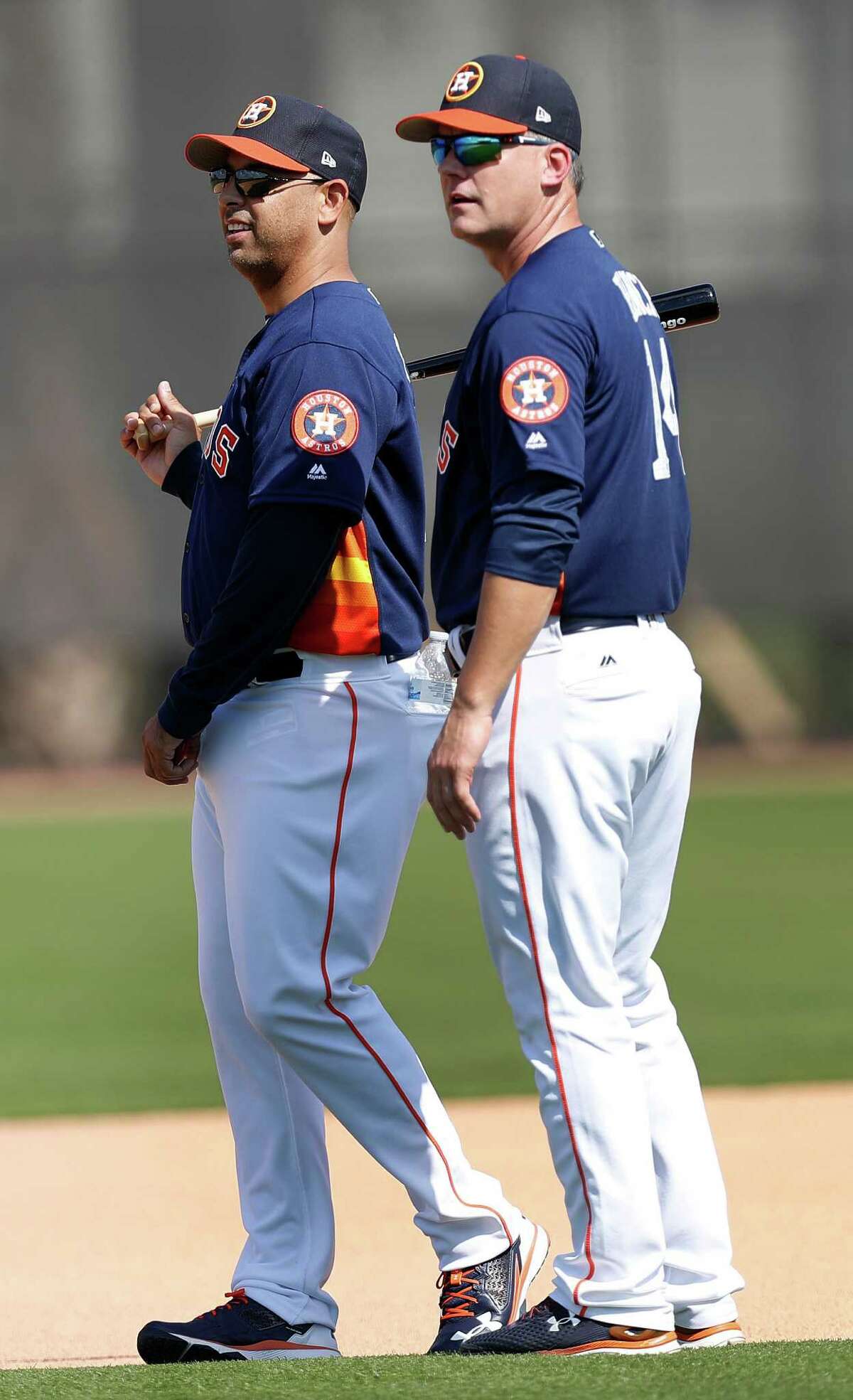 Houston Astros manager A.J. Hinch chats with his bench coach Alex Cora as the Astros pitchers and catchers held their first workout of spring training at The Ballpark of the Palm Beaches, in West Palm Beach, Florida, Tuesday, February 14, 2017.