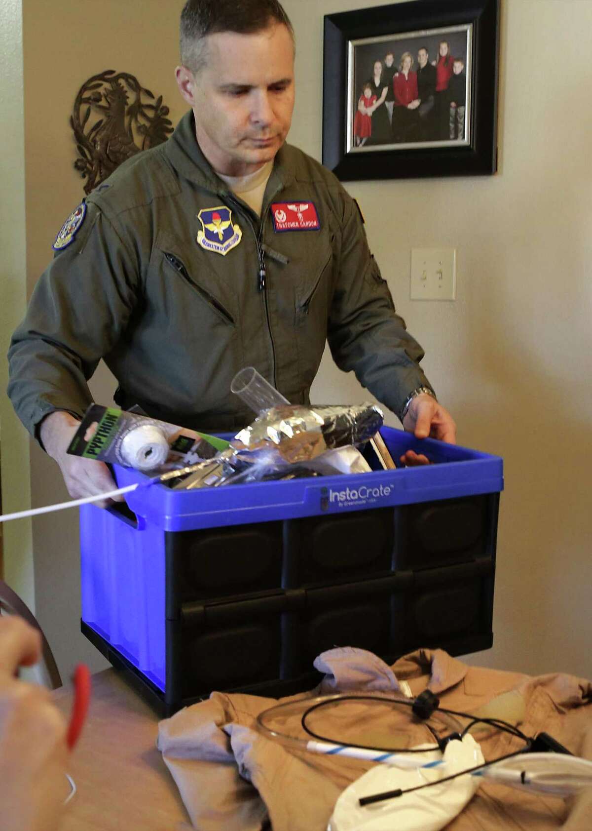 Col. Dr. Thatcher Cardon carries a box of everyday supplies he bought at dollar and hardware stores to create his MACES Perineal Access & Toileting System.