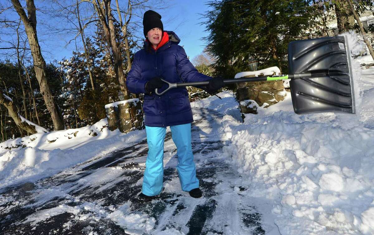 Moriah Agovino shovels snow outside her home on Cross Highway Friday February 10, 2017, following the snowstorm Thursday that dumped up to a foot of snow in Westport, Conn.